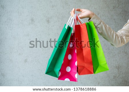 Closeup of woman holding shopping bags.