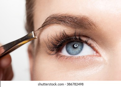 Closeup Of A Woman Making A Shape Eyebrows With Tweezers