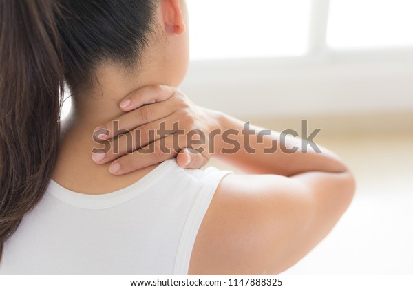 Closeup woman neck and shoulder pain and injury.\
Health care and medical\
concept.