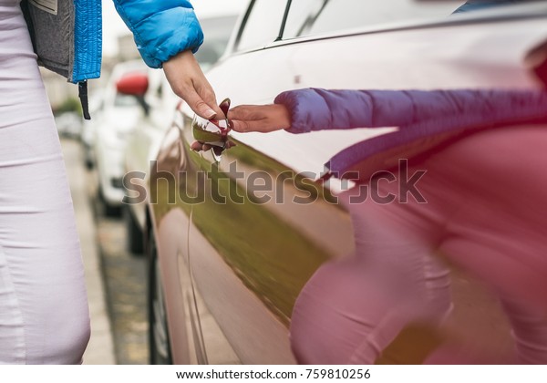Close-up of woman opening a car door.  hand opening\
the car door. Chauffeur open car door. Woman Opening door of the\
modern, new car