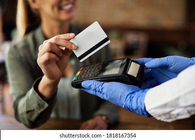 Close-up Of Woman Paying Contactless With Credit Card In A Cafe. 