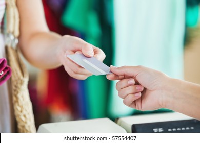 Close-up Of A Woman Paying With Her Credit Card In A Shop