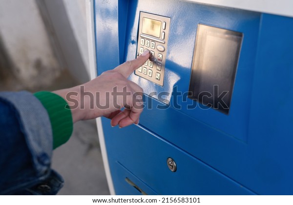 Close-up\
of woman paying for parking at teller machine in city. Parking fee,\
operated ticket machine or pay station\
concept