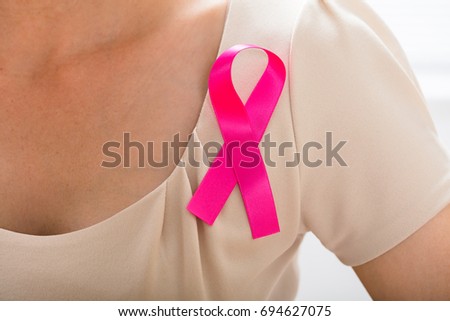 Close-up Of A Woman With Pink Ribbon To Support Breast Cancer Cause