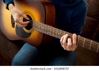 Close-up Woman Playing Acoustic Guitar. Selective Focus