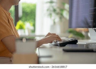 Close-up of a woman programmer typing code in a server room, showcasing expertise in technology, software development, and digital innovation.