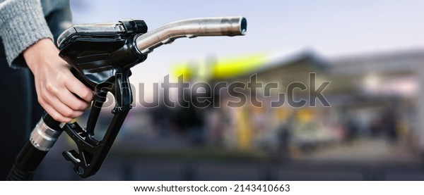 Closeup of woman pumping gasoline fuel in car at
gas station. Petrol or gasoline being pumped into a motor.
Transport concept