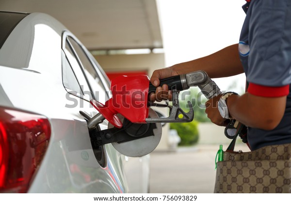 \
Closeup\
of woman pumping gasoline fuel in car at gas station. Petrol or\
gasoline being pumped into a motor vehicle\
car.