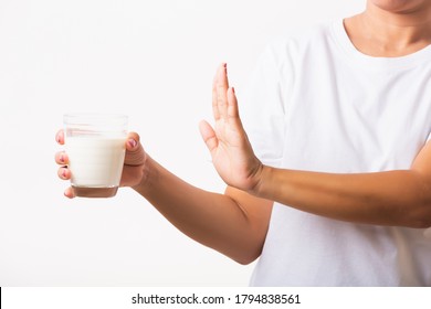 Closeup Woman Raises A Hand To Stop Sign Use Hand Holding Glass Milk She Is Bad Stomach Ache Has Bad Lactose Intolerance Unhealthy Problem With Dairy Food, Studio Shot Isolated On White Background