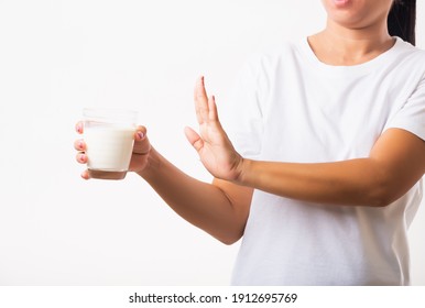 Closeup Woman Raises A Hand To Stop Sign Use Hand Holding Glass Milk She Is Bad Stomach Ache Has Bad Lactose Intolerance Unhealthy Problem With Dairy Food, Studio Shot Isolated On White Background