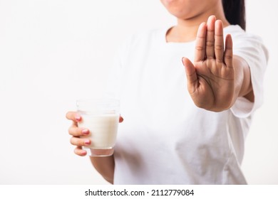 Closeup Woman Raises A Hand To Stop Sign Use Hand Holding Glass Milk She Is Bad Stomach Ache Has Bad Lactose Intolerance Unhealthy Problem With Dairy Food, Studio Shot Isolated On White Background