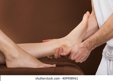 Close-up Of A Woman Receiving Foot Massage From A Male Therapist At A Beauty Spa