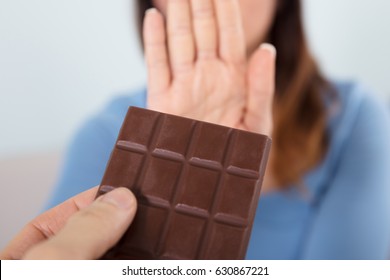 Close-up Of A Woman Rejecting Chocolate Bar