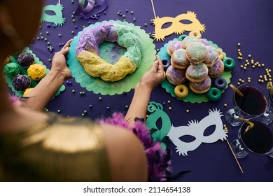 Close-up Of Woman Setting The Table For Mardi Gras Celebration And Serving King Cake. 