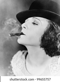 Closeup of woman smoking cigar