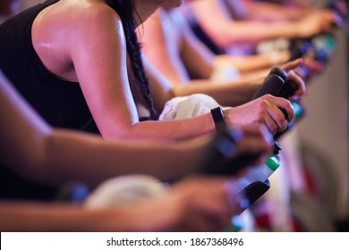 Closeup of woman with sweaty shoulders on a bike in a spin class - Powered by Shutterstock