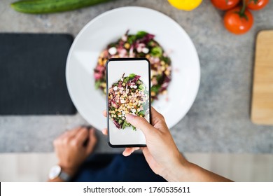 Close-up Of Woman Taking Picture Of Food With Mobile Phone