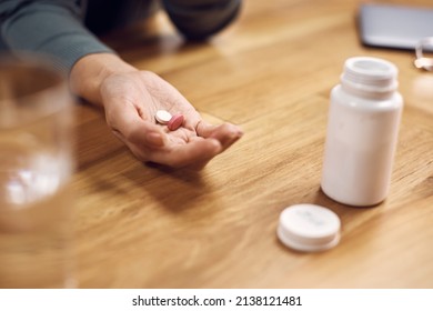 Close-up Of Woman Taking Prescription Pills At Home.