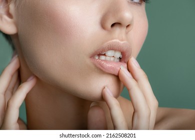 Close-up of woman touching her  lips. Portrait of beauty model with natural make up.  Spa, skincare and wellness.