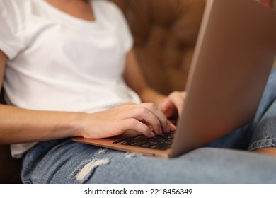 Close-up Of Woman Typing On Modern Laptop With Sticker On Cover. Remote Working Or Distance Work Concept