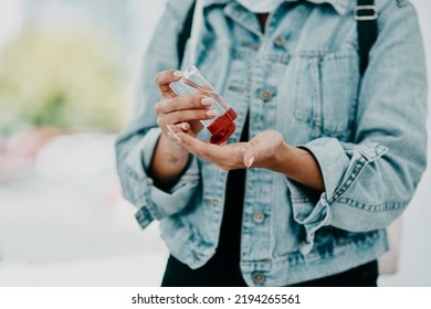 Closeup Of Woman Using Hand Sanitizer While In Public Or Travelling With Copy Space. Female Practicing Good Health And Hygiene, Sticking To Corona Regulations. Lady Suffering From OCD Or Germ Phobia