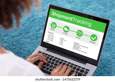 Close-up Of Woman Using Laptop With Application Showing Shipment Tracking On Screen