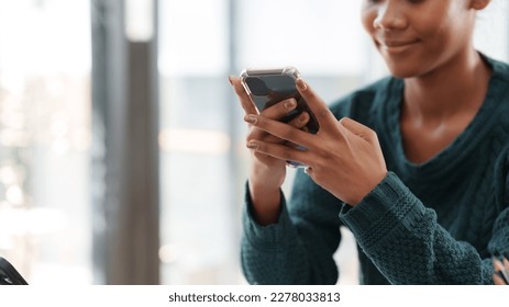 Close-up woman using smartphone to send text messages working or playing social media. - Powered by Shutterstock