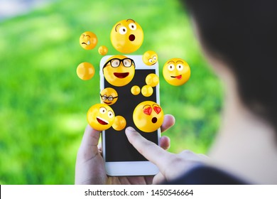 Close-up of woman using smartphone sending emojis. Social concept. - Shutterstock ID 1450546664
