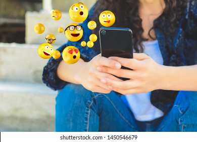 Close-up of woman using smartphone sending emojis. Social concept. - Shutterstock ID 1450546679