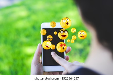 Close-up of woman using smartphone sending emojis. Social concept. - Shutterstock ID 1523564357