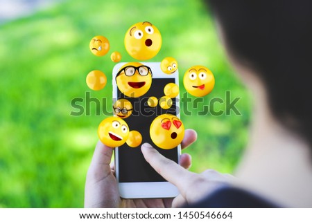 Similar – Nahaufnahme der Frau mit dem Smartphone, die Emojis sendet.