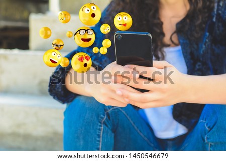 Similar – woman using smartphone sending emojis.