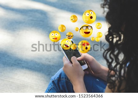 Similar – woman using smartphone sending emojis.