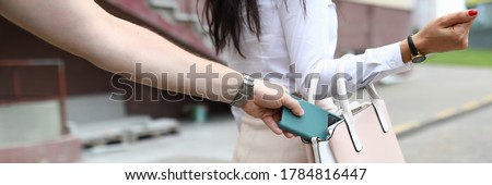 Close-up of woman walking on street. Man steal smartphone from females bag. Lady and street thief. Sad and problematic situation. Lost mobile phone concept