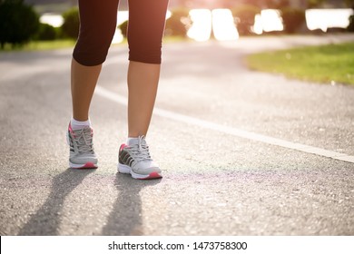 Closeup Woman Walking Towards On The Road Side. Step, Walk And Outdoor Exercise Activities Concept.