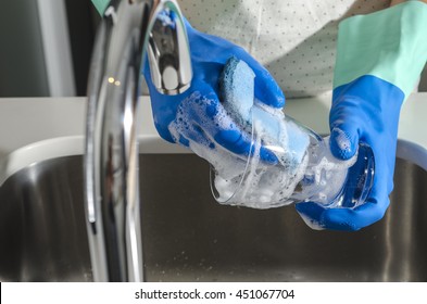 Closeup of woman washing a glass in the sink. - Shutterstock ID 451067704