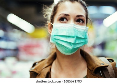 Close-up Of Woman Wearing Protective Mask On Her Face While Being In The Store During Coronavirus Epidemic. 