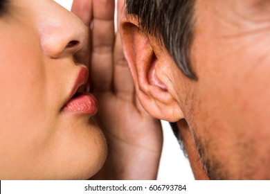 Close-up of woman whispering in man ear