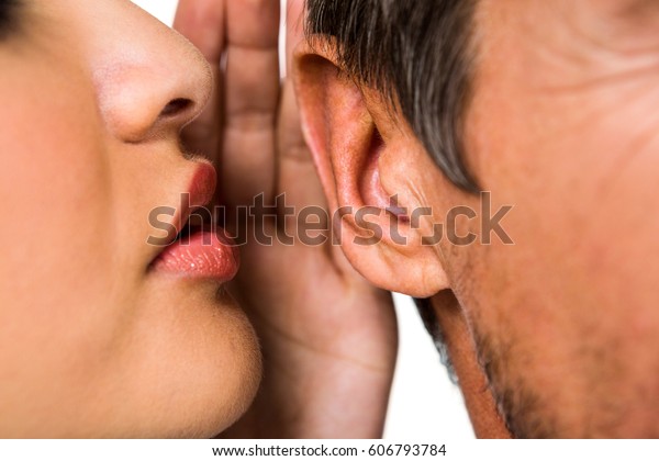 Close-up of woman\
whispering in man ear