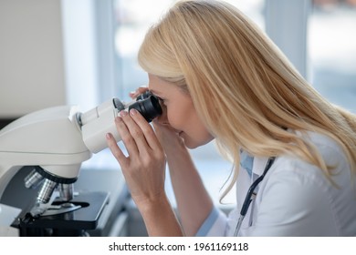 Close-up Of Woman Working Behind Microscope