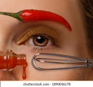 Close-up Of A Woman's Brown Eye With A Hot Sauce Bottle And A Whisk As A Mascara Tube And Applicator, Her Eyebrow Made Of A Red Hot Pepper	