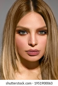 Close-up Of A Woman's Face. Portrait. Blond Straight Hair. Green Eyes. Not Bright Makeup.