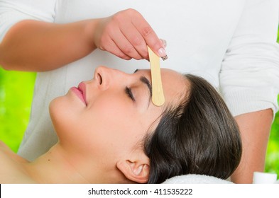  Closeup Womans Face Receiving Facial Hair Waxing Treatment, Hand Using Wooden Stick To Apply Wax, Beauty And Fashion Concept