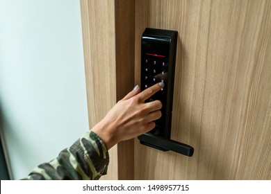 Closeup of a woman's finger entering password code on the smart digital touch screen keypad entry door lock in front of the room. Self Check-in, Modern security,Temporary codes.  - Shutterstock ID 1498957715