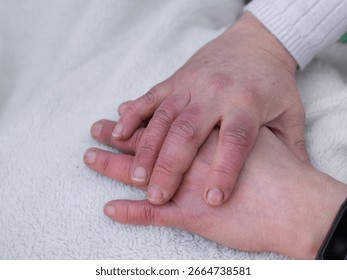 Close-up of a woman's hand, with circulation problems due to the cold. It's red and swollen.