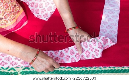 Closeup of a woman's hand doing patch work for applique in baby’s quilt or bed sheet. Concept of self employment woman and Female entrepreneurs in India.