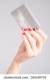 Closeup Of A Woman's Hand Holding Up A Credit Card.