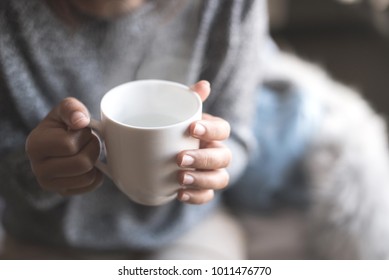 Close-up Of A Woman's Hand Holding A Cup Of Hot Water,