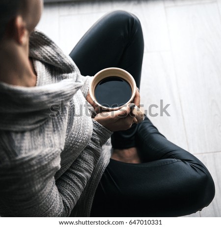Close-up of a woman's hand holding a cup of hot coffee. fashion, leisure