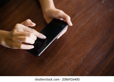 Close-up of woman's hand holding digital phone and typing message. concept of shopping or planning business on touchphone. Businesswoman using wireless device. - Shutterstock ID 2086926400